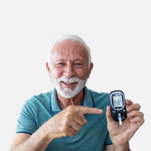 An older man with white hair and a beard smiling warmly holding a blood glucose meter in one hand